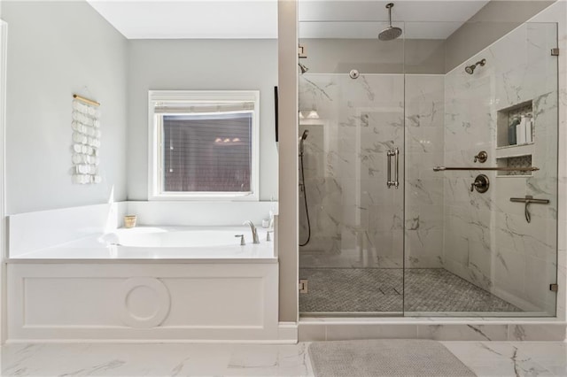bathroom with marble finish floors, a bath, and a marble finish shower
