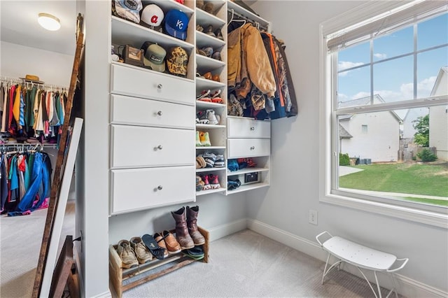 walk in closet with carpet flooring