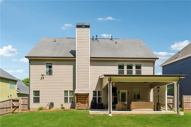 rear view of house with a gate, a patio area, an outdoor hangout area, ceiling fan, and a chimney