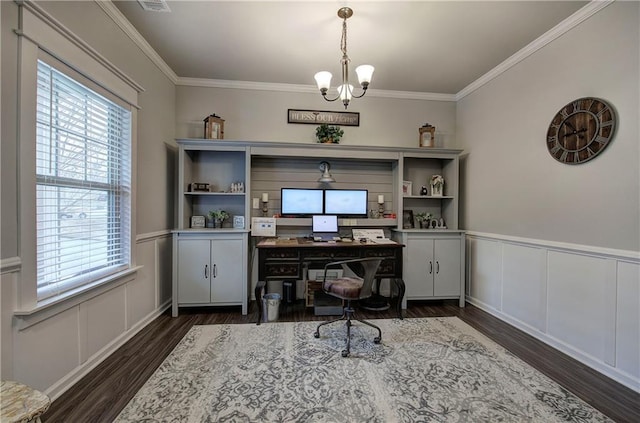 office area with dark hardwood / wood-style flooring, plenty of natural light, ornamental molding, and an inviting chandelier