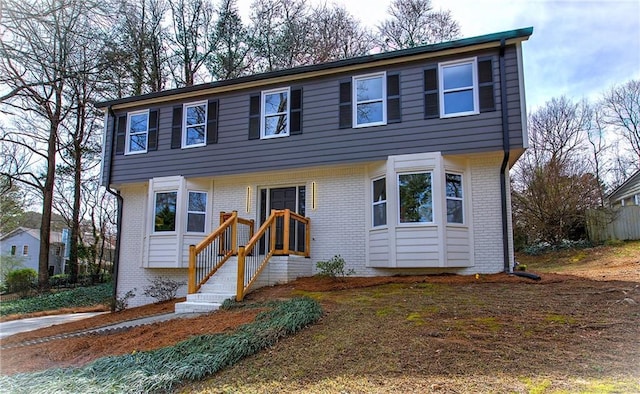 colonial-style house with brick siding