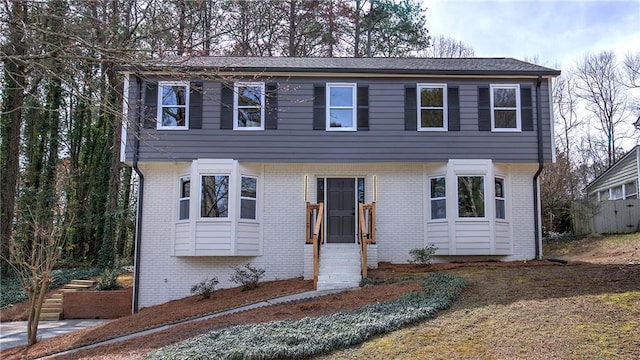 colonial home with brick siding