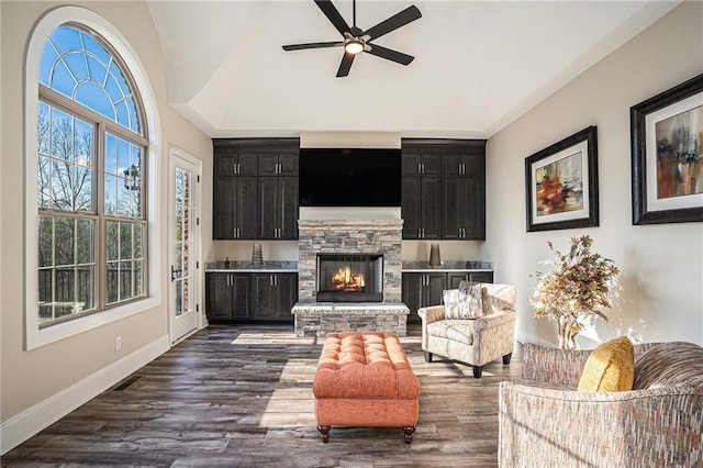 living room with lofted ceiling, ceiling fan, a fireplace, and dark hardwood / wood-style floors