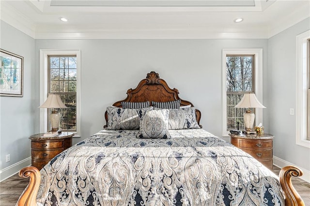 bedroom with crown molding and hardwood / wood-style floors