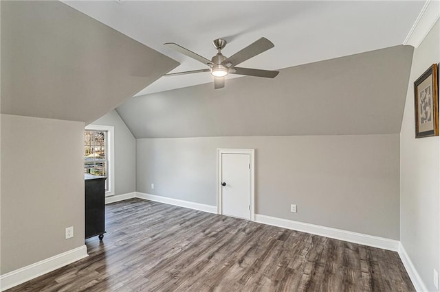 additional living space with ceiling fan, lofted ceiling, and dark wood-type flooring