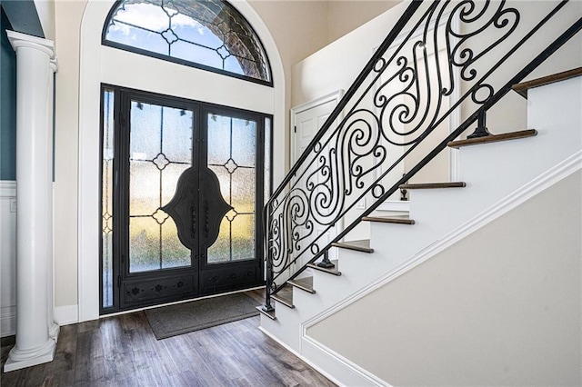 entrance foyer featuring french doors, decorative columns, and hardwood / wood-style floors