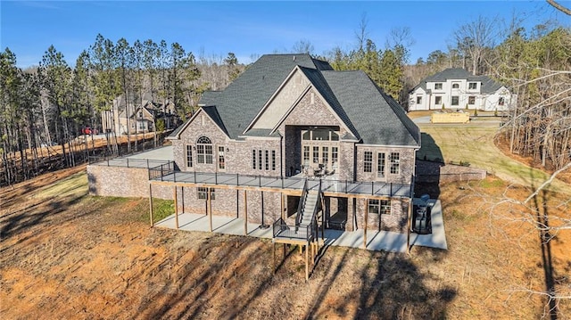 back of property with a lawn, a patio, and a deck