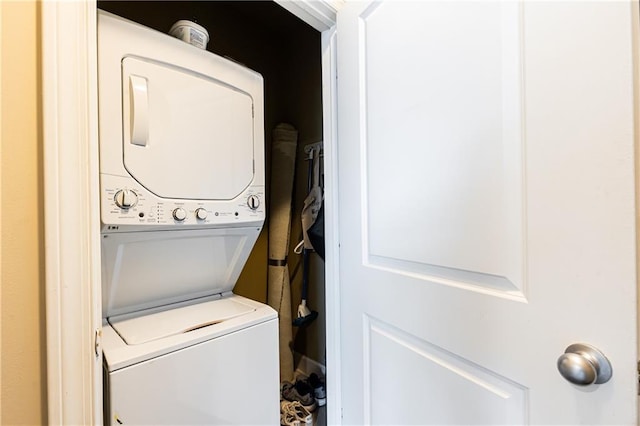 laundry room featuring stacked washer / drying machine