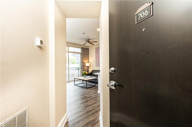 hall with hardwood / wood-style flooring