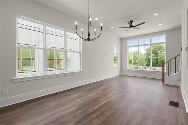 unfurnished dining area featuring baseboards, visible vents, and dark wood finished floors