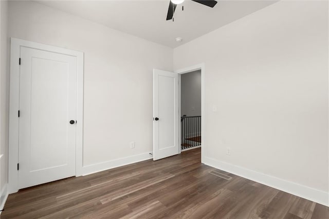 unfurnished bedroom featuring baseboards, a ceiling fan, and wood finished floors
