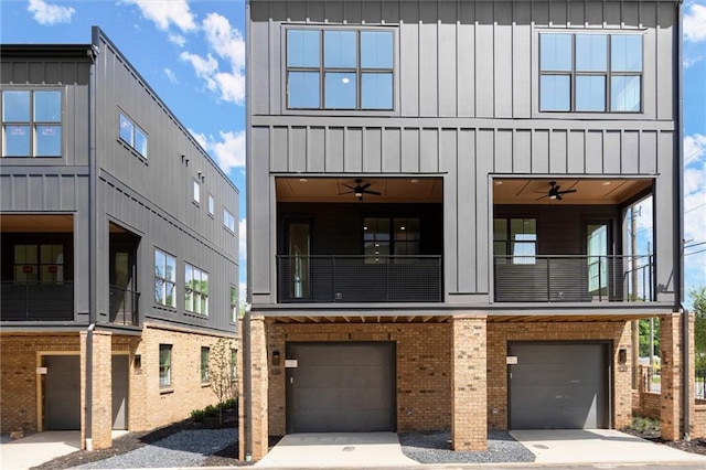 view of front of home featuring a balcony, board and batten siding, a garage, and brick siding
