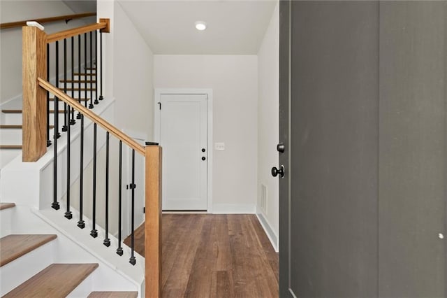interior space with recessed lighting, baseboards, wood finished floors, visible vents, and stairway