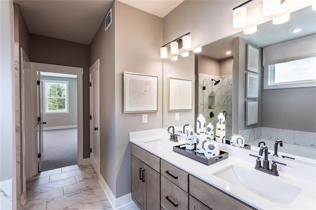 bathroom with shower with separate bathtub, vanity, and a healthy amount of sunlight