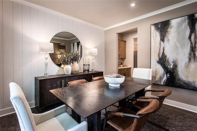 dining room with dark wood-type flooring and ornamental molding