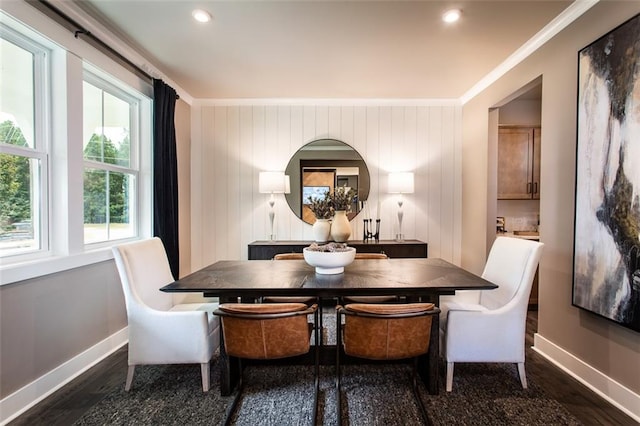 dining area featuring ornamental molding, wooden walls, and dark wood-type flooring