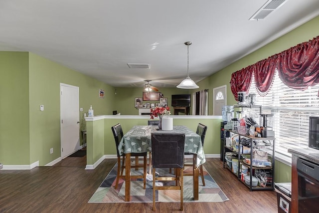 dining room with plenty of natural light and dark hardwood / wood-style floors