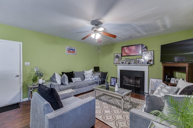 living room with ceiling fan and dark hardwood / wood-style flooring