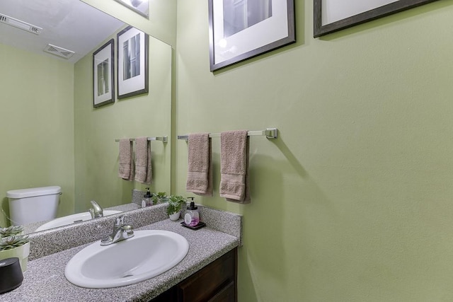 bathroom with toilet and vanity