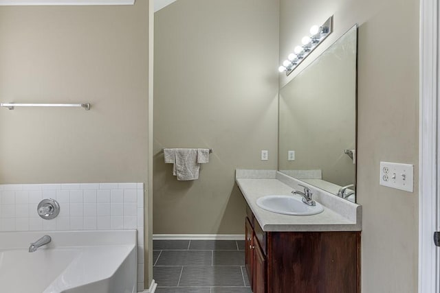 bathroom with vanity, tile patterned floors, and a washtub