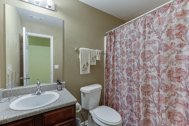 bathroom featuring toilet and vanity