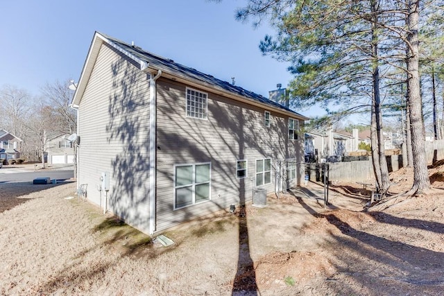 back of house featuring central air condition unit