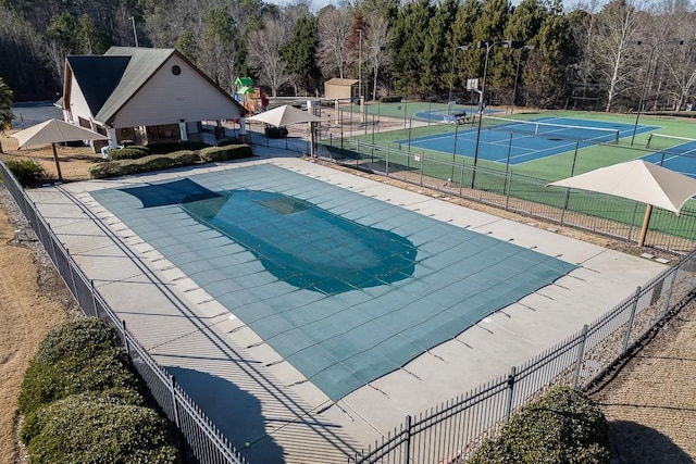 view of swimming pool featuring tennis court