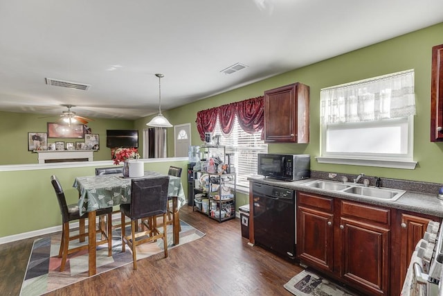 kitchen featuring black appliances, dark hardwood / wood-style flooring, sink, hanging light fixtures, and ceiling fan