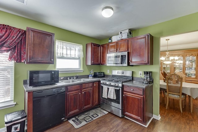 kitchen with decorative light fixtures, dark hardwood / wood-style floors, black appliances, sink, and a chandelier