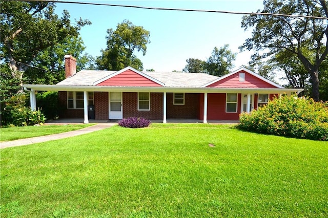 ranch-style home with a front yard, a porch, brick siding, and a chimney