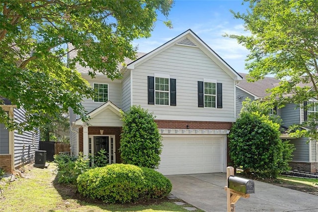 5712 Grande River Rd, Atlanta, GA 30349 - view of front of house with brick siding, a garage, concrete driveway, and central AC