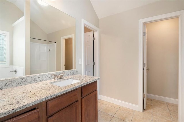 5712 Grande River Rd, Atlanta, GA 30349 - bathroom with lofted ceiling, vanity, tile patterned flooring, a shower, and baseboards