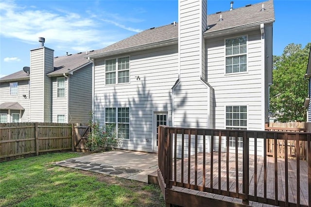 5712 Grande River Rd, Atlanta, GA 30349 - back of property with a patio area, a deck, a chimney, and roof with shingles