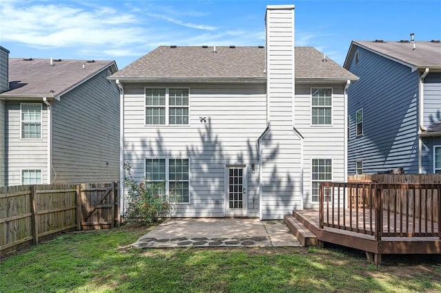 5712 Grande River Rd, Atlanta, GA 30349 - rear view of property with a patio area, a deck, a chimney, and roof with shingles