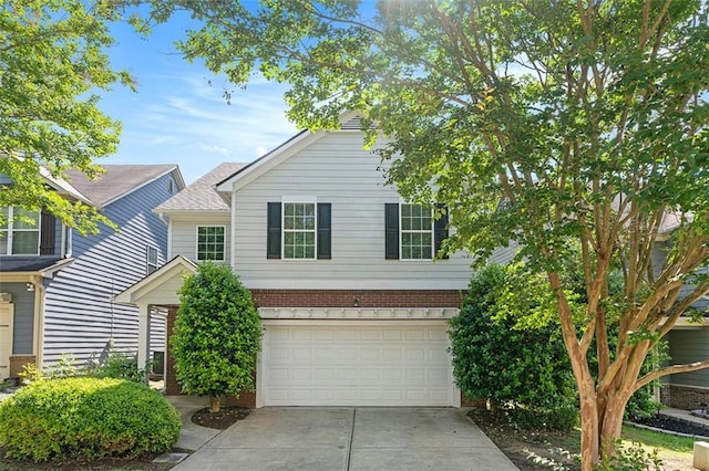 5712 Grande River Rd, Atlanta, GA 30349 - view of front of house featuring an attached garage, driveway, and brick siding