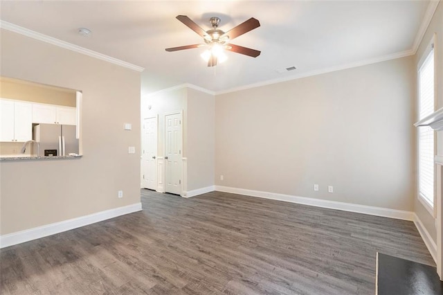 5712 Grande River Rd, Atlanta, GA 30349 - unfurnished living room with ceiling fan, dark wood finished floors, healthy amount of natural light, ornamental molding, and baseboards