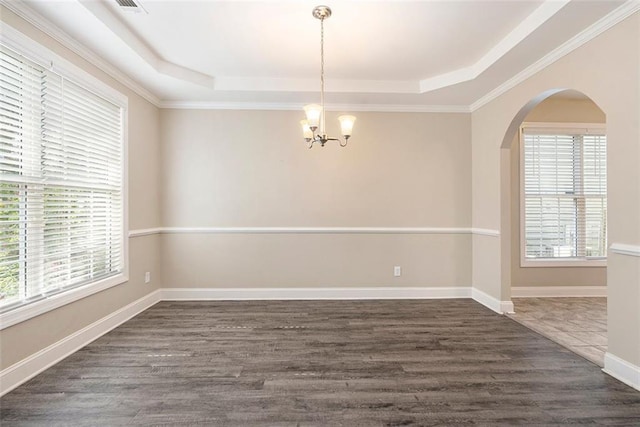 5712 Grande River Rd, Atlanta, GA 30349 - spare room with a tray ceiling, a chandelier, wood finished floors, and arched walkways