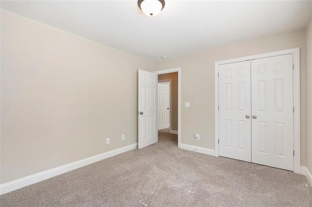 5712 Grande River Rd, Atlanta, GA 30349 - unfurnished bedroom with light colored carpet, baseboards, and a closet