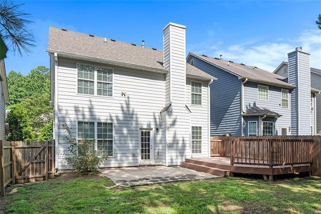 5712 Grande River Rd, Atlanta, GA 30349 - back of property with a patio, a deck, and a chimney