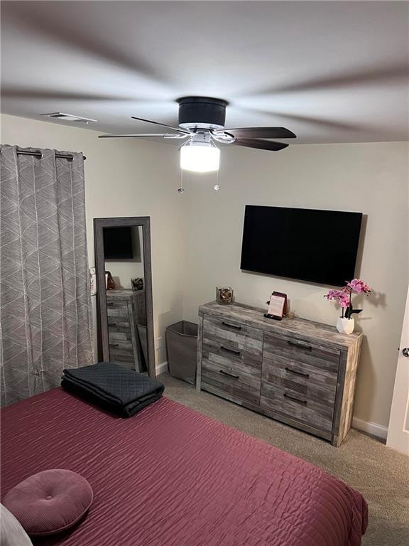 carpeted bedroom featuring ceiling fan