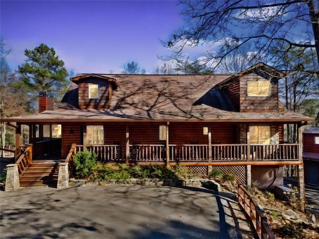 log cabin with covered porch