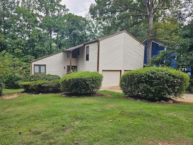 view of home's exterior featuring a garage and a yard