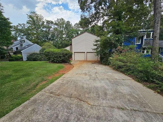 view of home's exterior with a garage and a yard