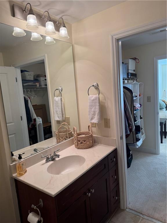 full bathroom with toilet, vanity, tile patterned floors, and shower / tub combo with curtain