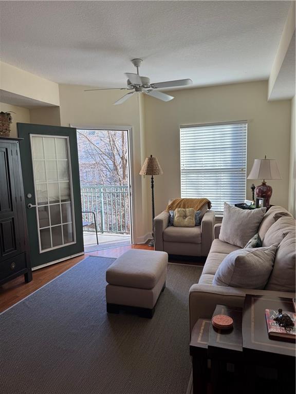 living room with ceiling fan and dark hardwood / wood-style floors