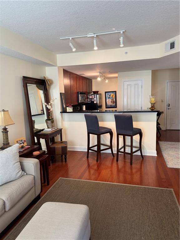 kitchen with stainless steel dishwasher, light hardwood / wood-style floors, decorative backsplash, and sink