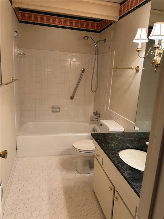 full bath featuring toilet, tile patterned floors, bathtub / shower combination, and vanity