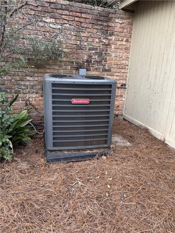 exterior details with cooling unit and brick siding