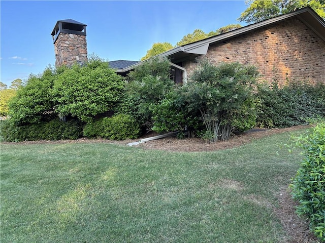 3358 Stonecrest Ct, Atlanta, GA 30341 - view of property exterior with a chimney, a lawn, and brick siding