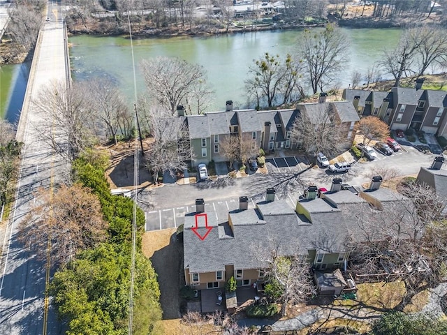 drone / aerial view with a water view and a residential view